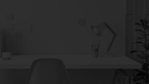 a desk with a lamp and pens in a cup on it