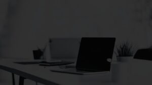 Angled view of an open laptop in a modern office space