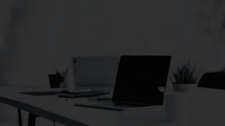 Angled view of an open laptop in a modern office space