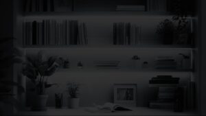 Modern bookshelf with potted plants, picture frames, and writing materials