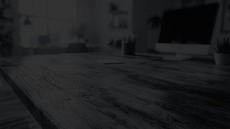 Close-up angled view of a modern wooden desk workspace
