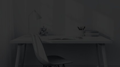 Close up view of a personal office space with a simple desk and chair