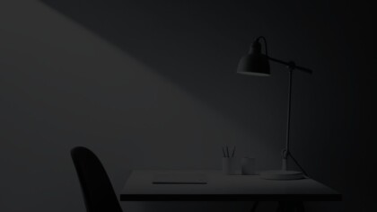 Side view of a minimal home office with a large overhead desk lamp