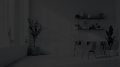 Simple office set up with table, chair, and decorative elements in a naturally lit room