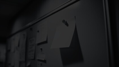 Close up view of a sticky note on a bulletin board