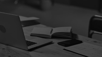 a desk with books and a laptop on it