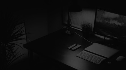 Workspace with a Laptop and Keyboard in Black and White