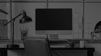 imac computer on a desk with a chair