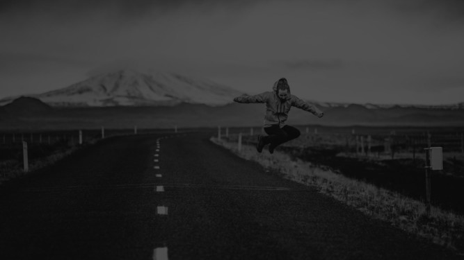 person jumping on an empty road